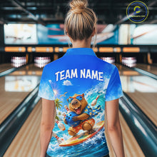 Load image into Gallery viewer, Person wearing a blue shirt with a bear graphic and 'TEAM NAME' text in a bowling alley.