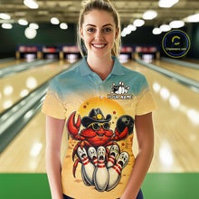 Load image into Gallery viewer, Person wearing a colorful shirt with a cartoon crab design in a bowling alley.
