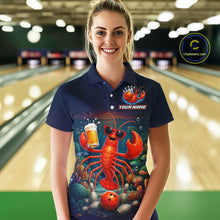 Load image into Gallery viewer, Person wearing a navy blue polo shirt with a colorful lobster design in a bowling alley.