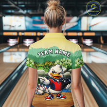 Load image into Gallery viewer, Person wearing a bowling-themed shirt with a cartoon duck character in a bowling alley.
