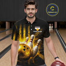 Load image into Gallery viewer, Man wearing a black bowling-themed shirt with a bowling ball and pins design, holding a red bowling ball in a bowling alley.