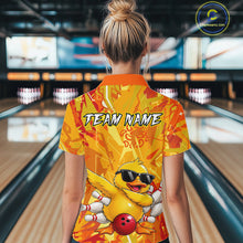 Load image into Gallery viewer, Person wearing a bright yellow bowling shirt with a duck design in a bowling alley.