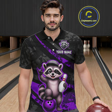 Load image into Gallery viewer, Man wearing a black and purple bowling shirt with a raccoon design on a bowling alley.
