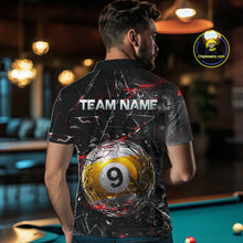 Load image into Gallery viewer, Man wearing a black collared polo shirt with shattered glass graphics, red accent streaks, a custom name area, and a large cracked 9-ball illustration across the lower back.