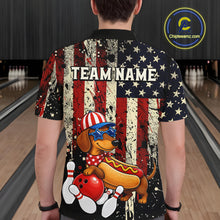 Load image into Gallery viewer, Person wearing a colorful shirt with a dog and hot dog design in a bowling alley.