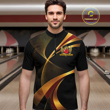 Load image into Gallery viewer, Man wearing a black and gold bowling shirt with a logo in a bowling alley.