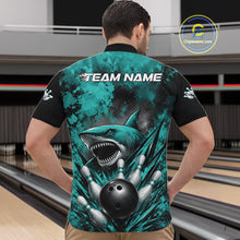 Load image into Gallery viewer, Person wearing a teal and black bowling shirt with a shark design at a bowling alley.