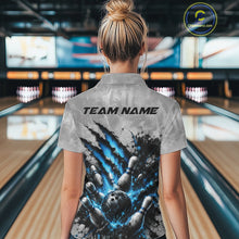 Load image into Gallery viewer, Back view of a female model wearing a gray bowling quarter zip shirt featuring a dramatic blue bowling ball striking pins graphic with claw-mark accents in a bowling lane.