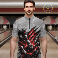 Load image into Gallery viewer, Male model wearing a gray bowling quarter zip shirt with a dramatic red bowling ball striking pins graphic, shown from the front in a bowling lane.