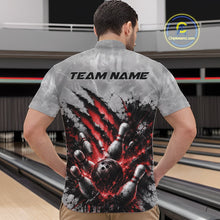 Load image into Gallery viewer, Front view of a male model wearing a gray bowling quarter zip shirt featuring a dramatic red bowling ball and pins graphic with claw-mark artwork at a bowling lane.