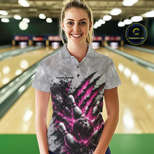 Load image into Gallery viewer, Front view of a female model wearing a gray bowling polo shirt featuring a dramatic pink bowling ball and pins graphic with claw-mark artwork in a bowling lane.