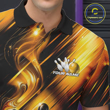 Load image into Gallery viewer, Close-up view of the left chest of a bowling polo shirt featuring a black and gold bowling ball striking pins with flowing metallic ribbon accents.