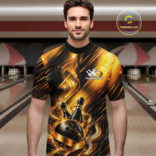 Load image into Gallery viewer, Male model wearing a bowling quarter zip shirt featuring a black and gold bowling ball striking pins with flowing metallic ribbon accents, shown from the front in a bowling lane.