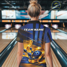 Load image into Gallery viewer, Back view of a female model wearing a bowling polo shirt featuring a glossy blue bowling ball and pins wrapped in elegant flowing gold ribbons at a bowling lane.