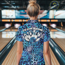 Load image into Gallery viewer, Back view of a woman standing at a bowling alley, wearing a gold, brown, and black leopard-print bowling polo with “Team Name” and bowling pins on the back.
