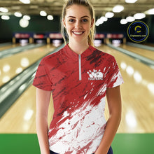 Load image into Gallery viewer, Front view of a female model in a bowling alley wearing a bowling quarter-zip shirt featuring a white paint splatter distressed sportswear design on a red shirt.
