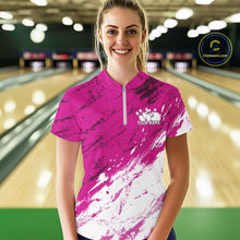 Load image into Gallery viewer, Woman wearing a pink and white bowling shirt with a logo and text in a bowling alley.