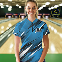 Load image into Gallery viewer, Woman wearing a blue bowling shirt with a logo and text in a bowling alley.