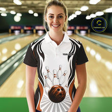 Load image into Gallery viewer, Female model at the bowling lane wearing a white, black, and orange bowling polo shirt, front view, featuring bowling ball striking pins graphics.