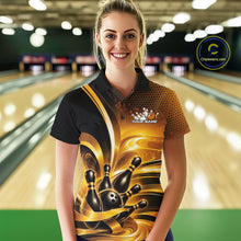 Load image into Gallery viewer, Front view of a female model inside a bowling center wearing a bowling polo shirt with glossy gold and black bowling ball and pins artwork.