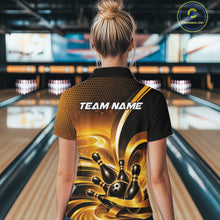 Load image into Gallery viewer, Back view of a female model at a bowling lane wearing a bowling polo shirt with glossy gold and black bowling ball and pins artwork.