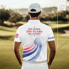 Load image into Gallery viewer, Man on a golf course wearing a white polo shirt with a patriotic design and text.