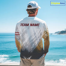 Load image into Gallery viewer, Person wearing a sports jersey with 'TEAM NAME' on the back, standing by the ocean.