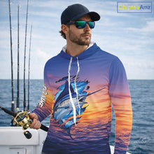Load image into Gallery viewer, Angler wearing Marlin Fishing Sunset custom long sleeve hooded marlin offshore fishing shirt on the boat at sunset