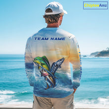 Load image into Gallery viewer, Angler wearing mahi mahi wahoo tuna blue performance fishing shirt on boat with custom team name on the back