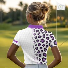 Load image into Gallery viewer, Woman on a golf course wearing a white polo shirt with purple leopard print