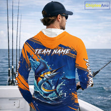 Load image into Gallery viewer, Angler wearing Custom Marlin Fishing Blue Orange long sleeve hooded saltwater fishing jersey 