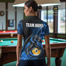 Load image into Gallery viewer, Back view of woman wearing a blue thunder lightning dragon 8 ball and 9 ball pool shirt in a billiards hall.