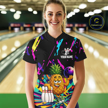Load image into Gallery viewer, Woman wearing a colorful pineapple bowling polo shirt at a bowling alley front view.