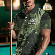 Load image into Gallery viewer, Man wearing a green camo American flag billiard jersey beside a pool table front view.