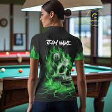 Load image into Gallery viewer, Back view of woman wearing a green flaming skull 8 ball pool shirt in a billiards hall.